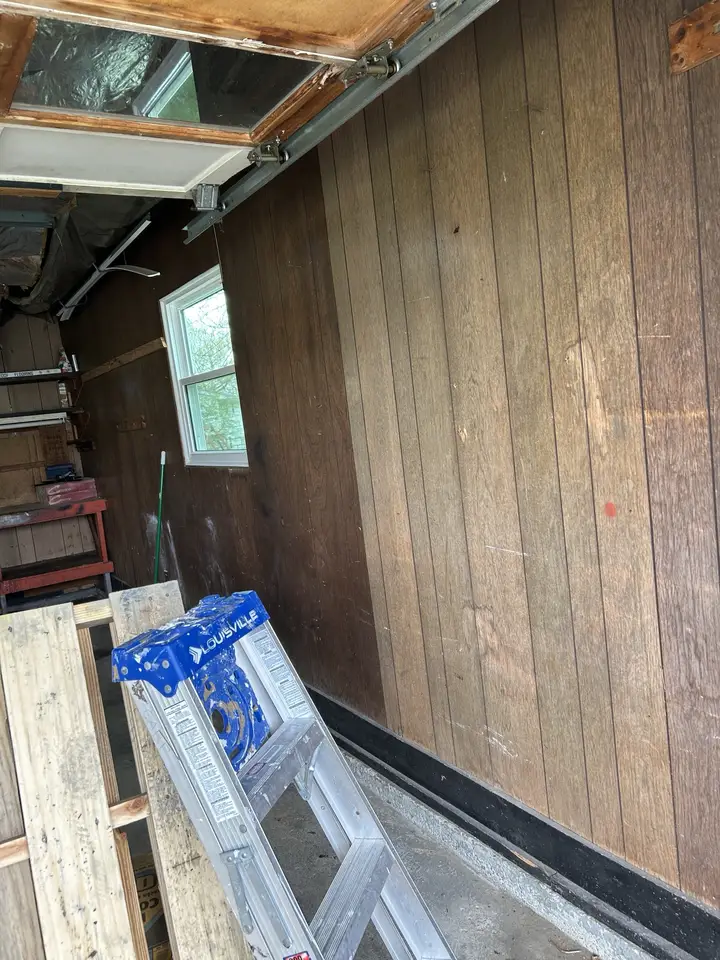 Garage before, with dated wood paneling
